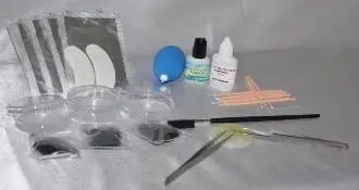 A table with some items that include scissors, glue and a brush.