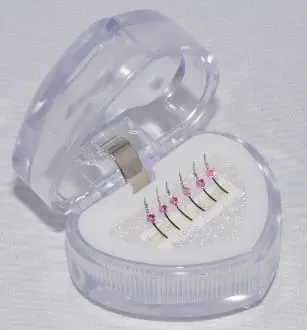 A heart shaped box with an array of dental floss inside.