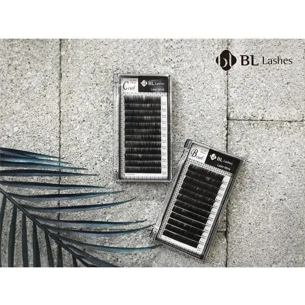 A pair of black lashes on the side of a wall.