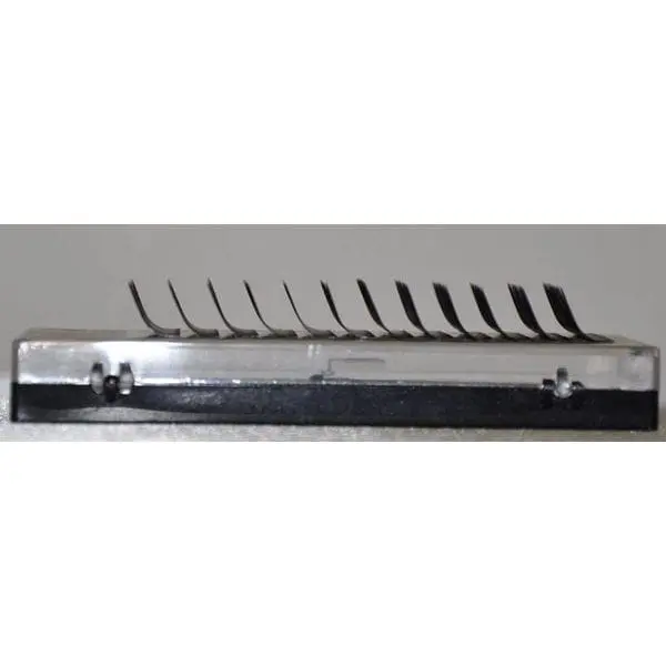 A row of metal blades on top of a black and silver object.