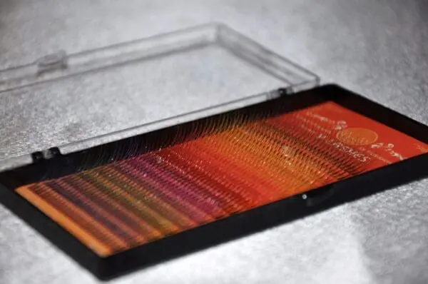 A box of colored pencils sitting on top of the table.