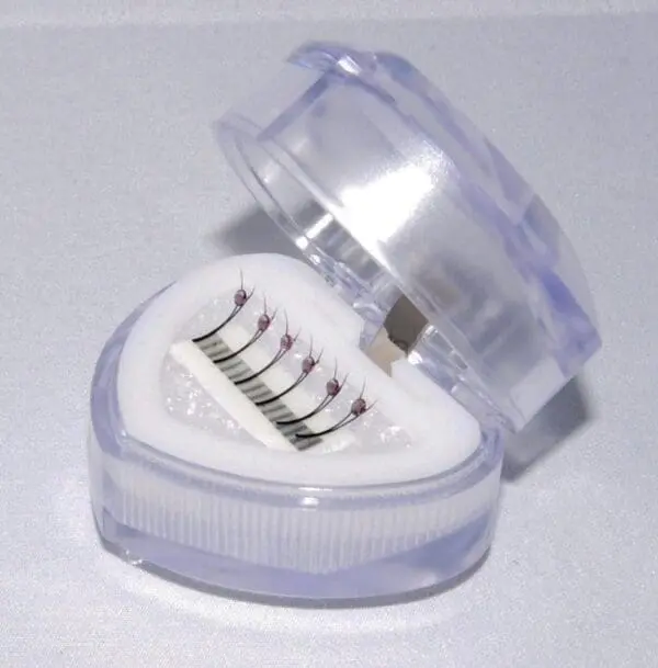 A heart shaped container with four different sized batteries inside.