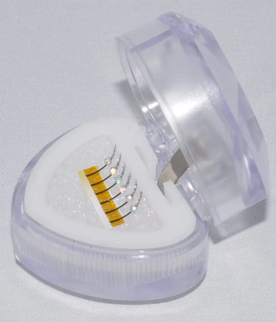 A heart shaped container with five different batteries inside.