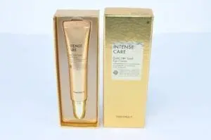A gold box with a tube of intense care eye cream in it.