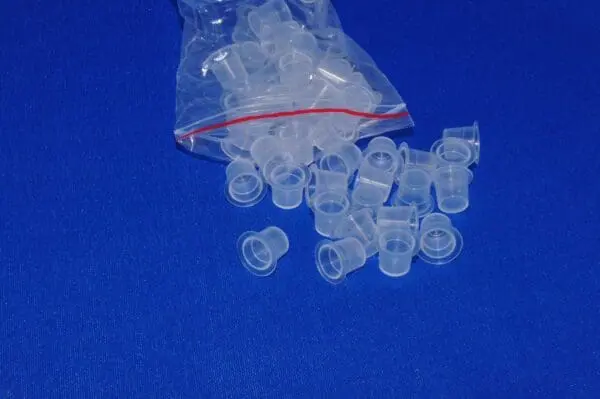 A bag of plastic cups on top of a blue table.