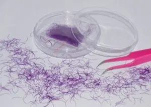 A plastic container with purple hair in it