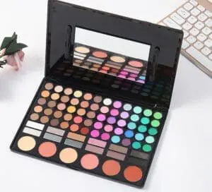 A table with a mirror and some makeup products