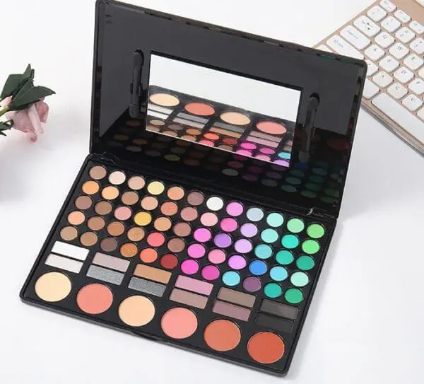 A table with a mirror and some makeup products