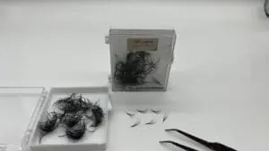 A box of hair with some scissors and other items