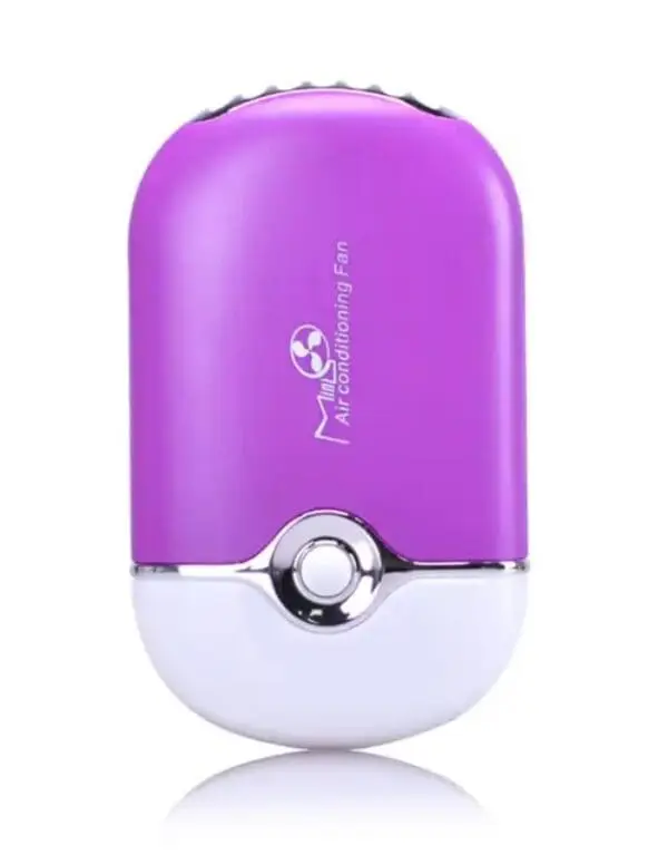 A purple and white humidifier sitting on top of a table.