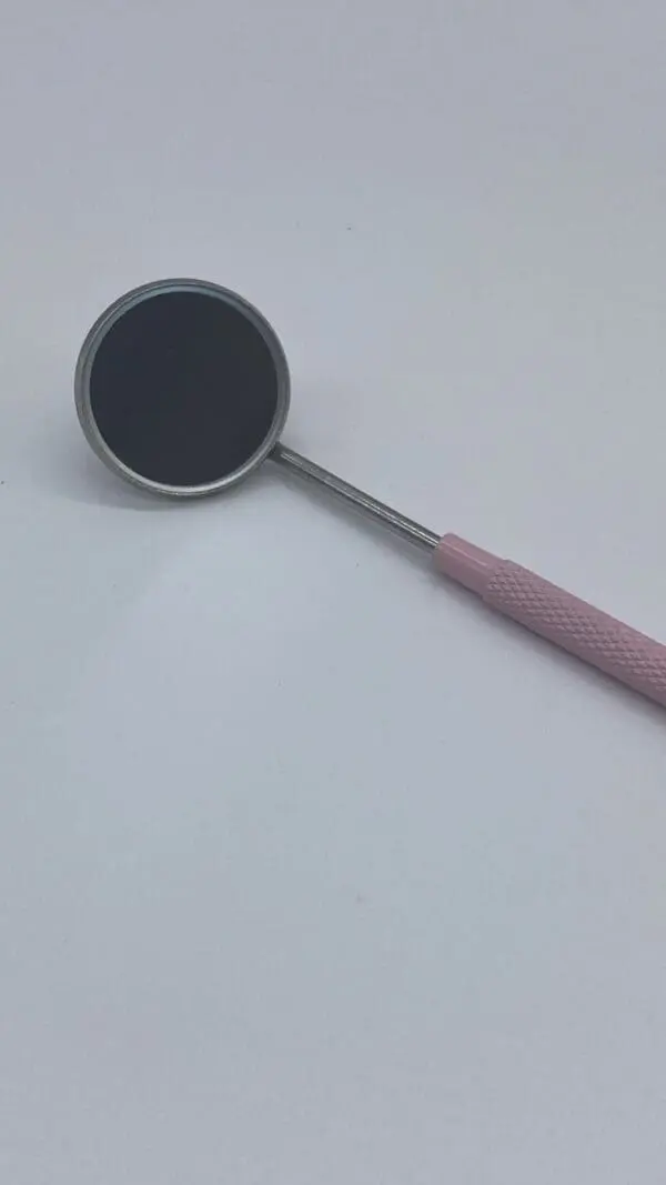 A pink and silver spoon with a black top