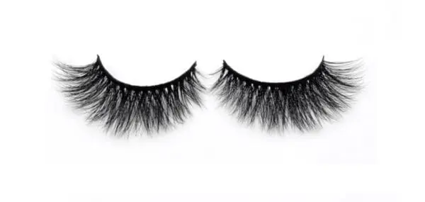 A pair of fake eyelashes on top of white background.