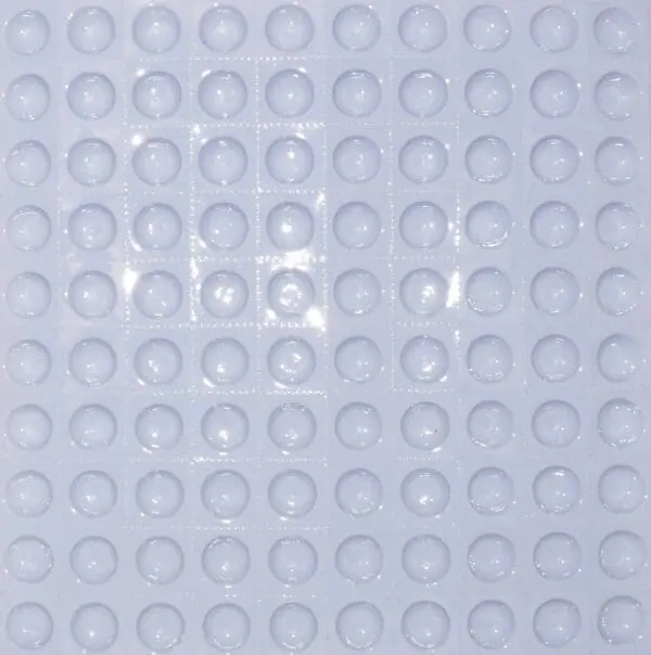 A close up of a white tile with circles