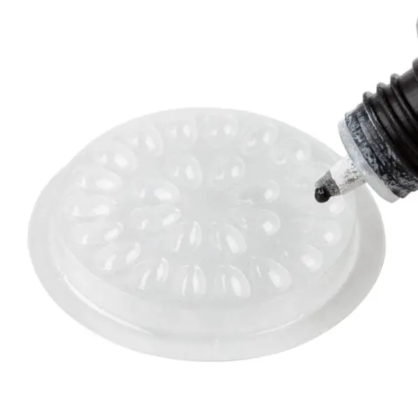 A person is filling an air cushion with glue.