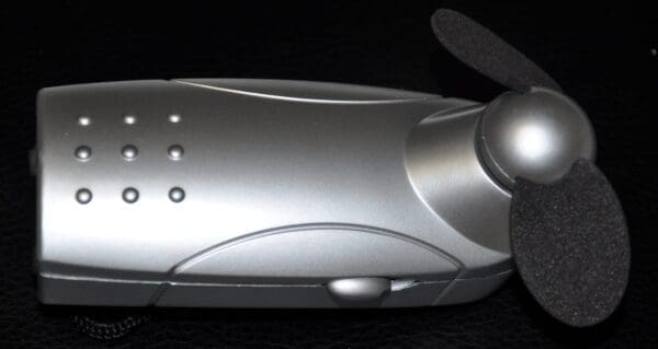 A silver mouse with a small fan on the side.