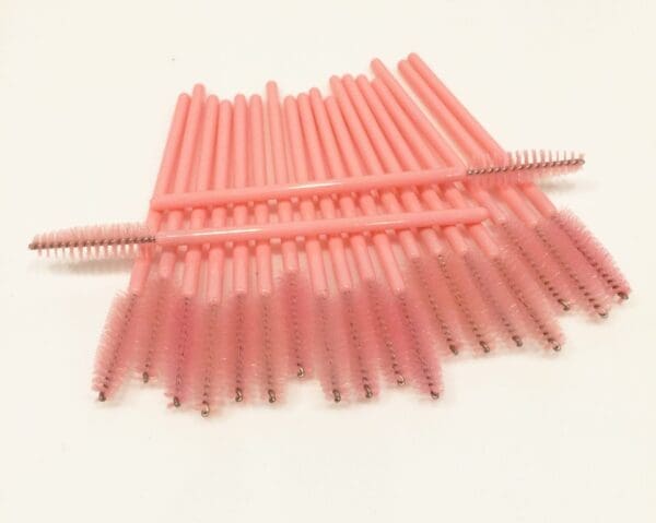 A bunch of pink plastic straws are stacked on top of each other