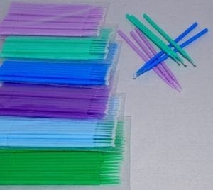 A table with many different colored straws and one straw in the background.