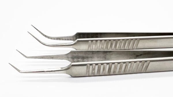 Three surgical instruments are shown in a row.