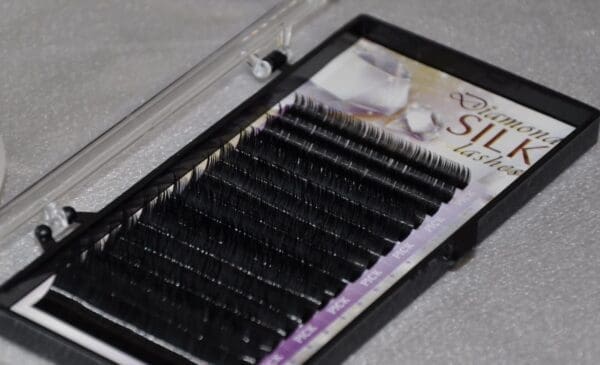 A box of individual lashes in the shape of a heart.