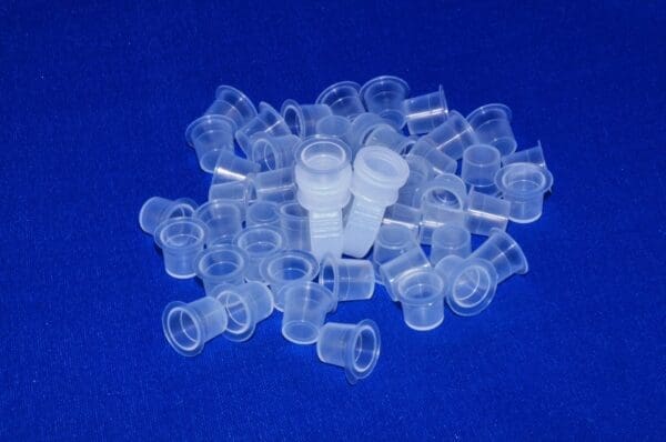 A pile of plastic cups on top of blue surface.