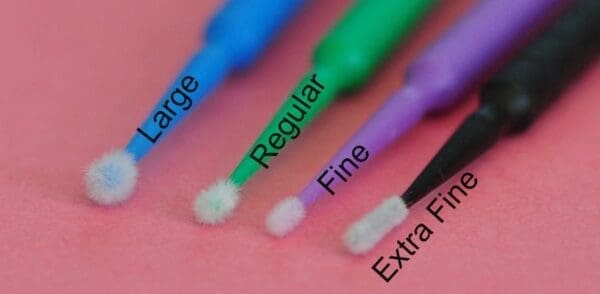 A close up of three different types of toothbrushes