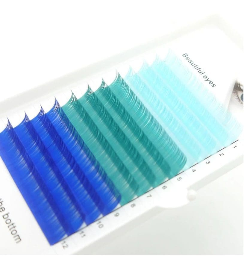 A close up of blue colored lashes on top of a white box.