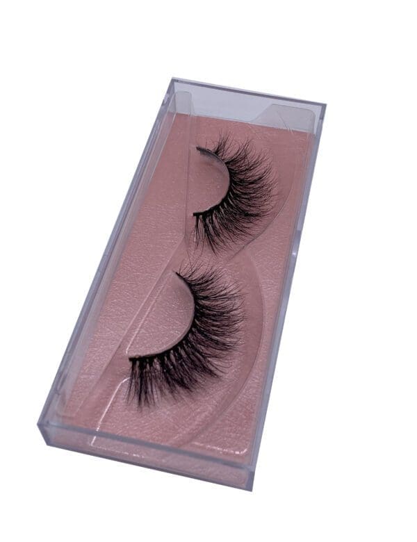 A pair of fake eyelashes in a pink box.