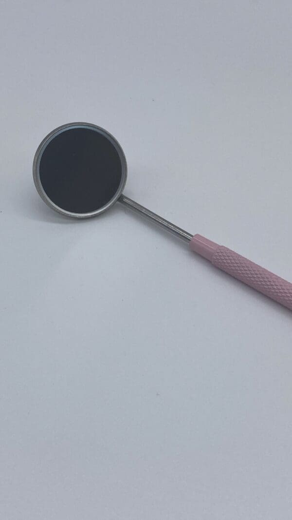 A pink and silver spoon with a black top