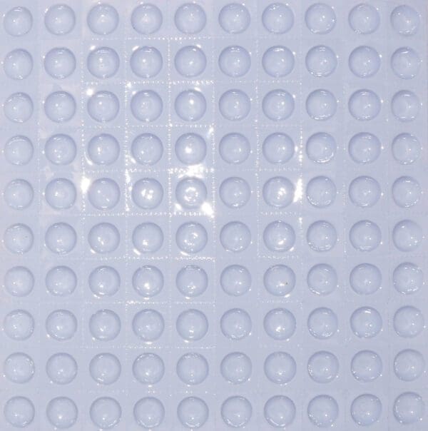 A close up of a white tile with circles